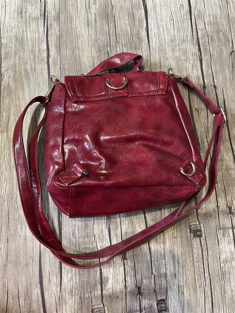 Red Crossbody Bag (Category: Cross-body Bags) located in Pasig City. Submitted by ishyk (Listing ID 1427661297, Image 3). Description: Red 3 way genuine leather bag (crossbody, backpack, shoulder bag) features a flap closure with a gold-tone clasp. It has a single adjustable strap and a top handle. The interior includes a main compartment and a zippered pocket. The bag's exterior has a textured finish..