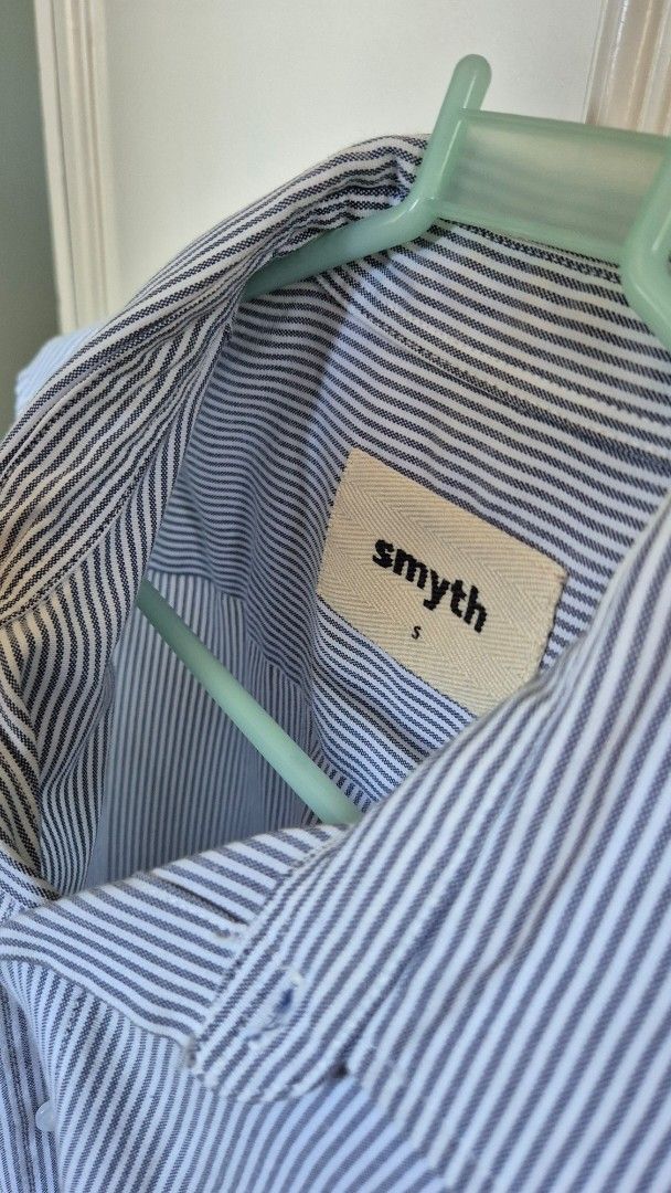Smyth Striped Shirt - Size S (Category: Tshirts & Polo Shirts ) located in Antipolo. Submitted by declutterinboy (Listing ID 1427661915, Image 2). Description: Shirt features a classic striped pattern in blue and white. It has a collared neckline and long sleeves with buttoned cuffs. The shirt includes a chest pocket and a button-down closure. The brand label is visible inside the collar. It is a size small..