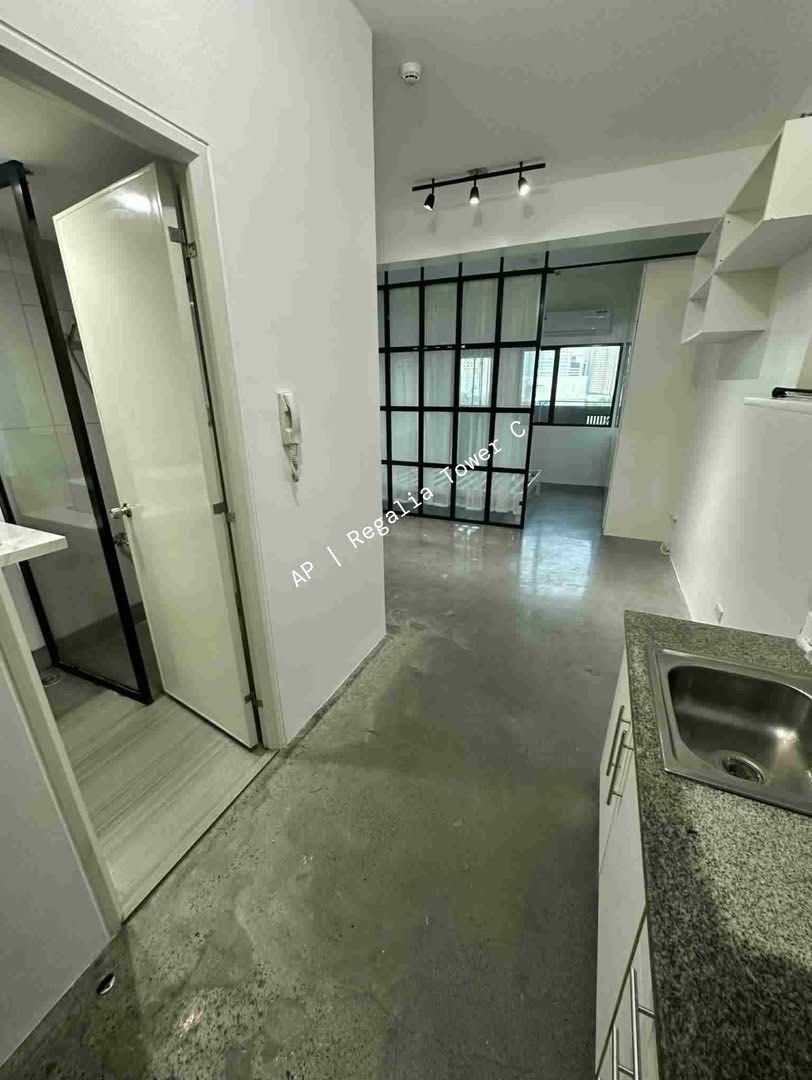 Studio / 1BR SOHO Unit in Regalia Park Tower C (Category: Apartments & Condos) located in Quezon City. Submitted by general_cleanup (Listing ID 1427671430, Image 2). Description: FOR SALE: Studio / 1BR SOHO Unit in Regalia Park Tower C Unit Highlights • 33.69 sqm • 7th Floor • SOHO Unit (Perfect for Home + Business) • With Balcony – Araneta / Antipolo View • 24/7 Security Upgraded & Move-In Ready • French-style glass partition (Studio → 1BR feel)