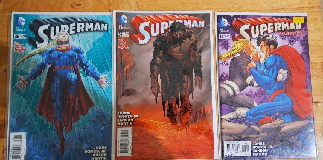 Superman Comic Book - The New 52 Issue 32 to 38 (Category: Comics & Manga) located in Quezon City. Submitted by ernestamaru2 (Listing ID 1427740780, Image 3). Description: Collection of Superman comic books from The New 52 series. Includes issues 32, 33, 34, 35, 36, 37, and 38. Features artwork by Geoff Johns, John Romita Jr., and Klaus Janson. Each comic has a $3.99 price tag. The comics showcase various Superman covers and storylines..