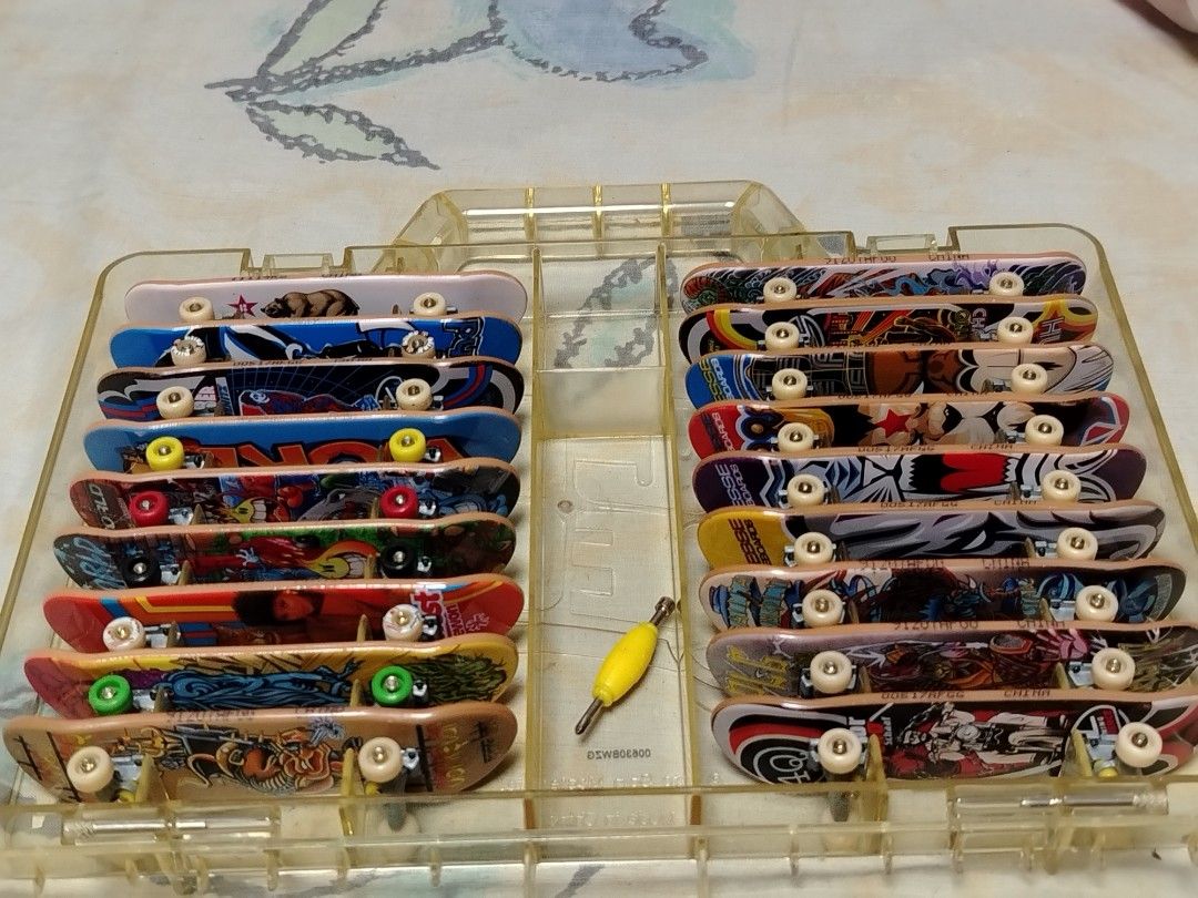 Tech Deck Finger Skateboards Set (Category: Action & Battle Toys) located in Quezon City. Submitted by 09277011179 (Listing ID 1427720891, Image 3). Description: set of Tech Deck finger skateboards in a clear carrying case. Includes multiple skateboards with various designs and colors. Also comes with a small yellow tool. The case has a handle for easy carrying and storage but looses one lock... Great for collectors or for playing. pm for faster 