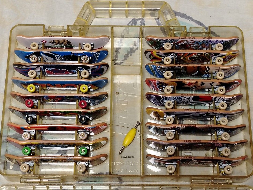 Tech Deck Finger Skateboards Set (Category: Action & Battle Toys) located in Quezon City. Submitted by 09277011179 (Listing ID 1427720891, Image 2). Description: set of Tech Deck finger skateboards in a clear carrying case. Includes multiple skateboards with various designs and colors. Also comes with a small yellow tool. The case has a handle for easy carrying and storage but looses one lock... Great for collectors or for playing. pm for faster 