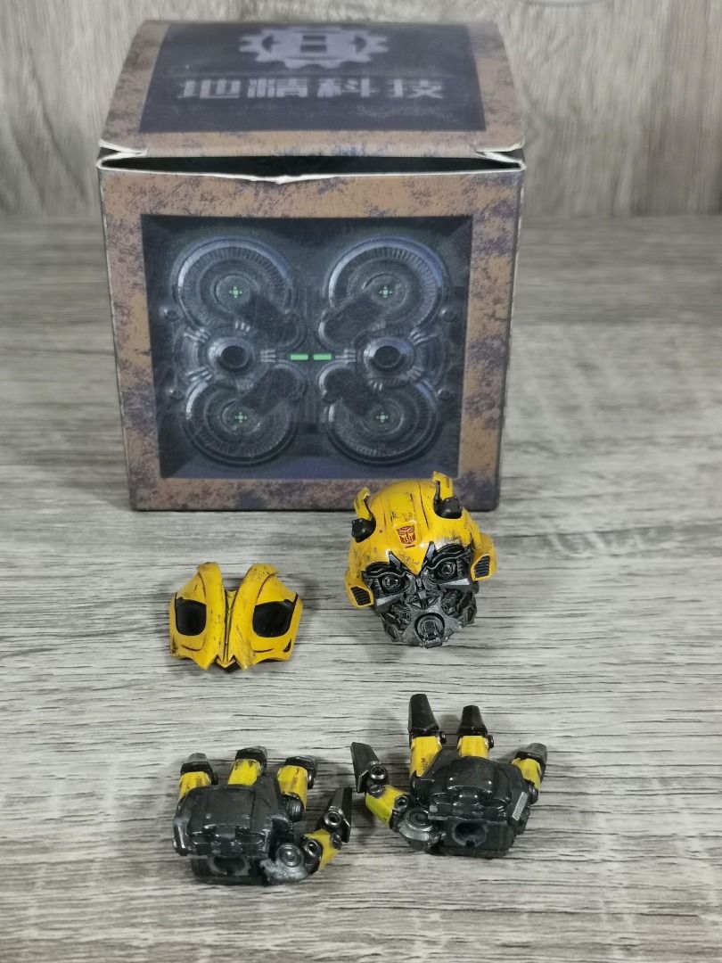 THREEZERO DLX TLK BUMBLEBEE UPGRADE HEAD AND ARTICULATED HANDS (Category: Figurines & Statues) located in Angeles City. Submitted by swodahs (Listing ID 1427649522, Image 2). Description: Listing includes Bumblebee action figure parts. It features one head, a pair of articulated hands, and a faceplate. The parts are yellow and black, with detailed paintwork. The parts come with the original box. The head has magnet activated light-up eyes. .