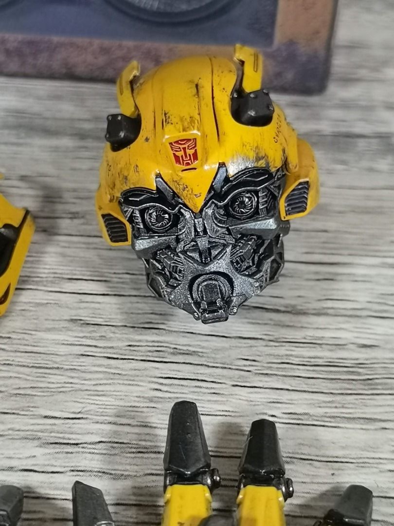 THREEZERO DLX TLK BUMBLEBEE UPGRADE HEAD AND ARTICULATED HANDS (Category: Figurines & Statues) located in Angeles City. Submitted by swodahs (Listing ID 1427649522, Image 3). Description: Listing includes Bumblebee action figure parts. It features one head, a pair of articulated hands, and a faceplate. The parts are yellow and black, with detailed paintwork. The parts come with the original box. The head has magnet activated light-up eyes. .