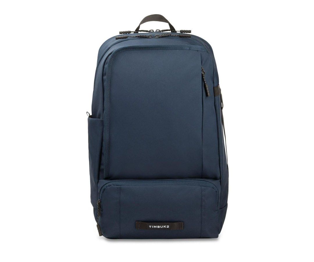 Timbuk2 Parker Backpack (Category: Backpacks) located in General Trias. Submitted by charlie.shop (Listing ID 1427757325, Image 1). Description: Timbuk2 Parker Backpack in navy blue. Features multiple compartments, including a padded laptop sleeve and a front organizer pocket. Includes a water bottle pocket and a key leash. The interior is made with recycled materials. The backpack has padded shoulder straps and a breathable back panel for comfor
