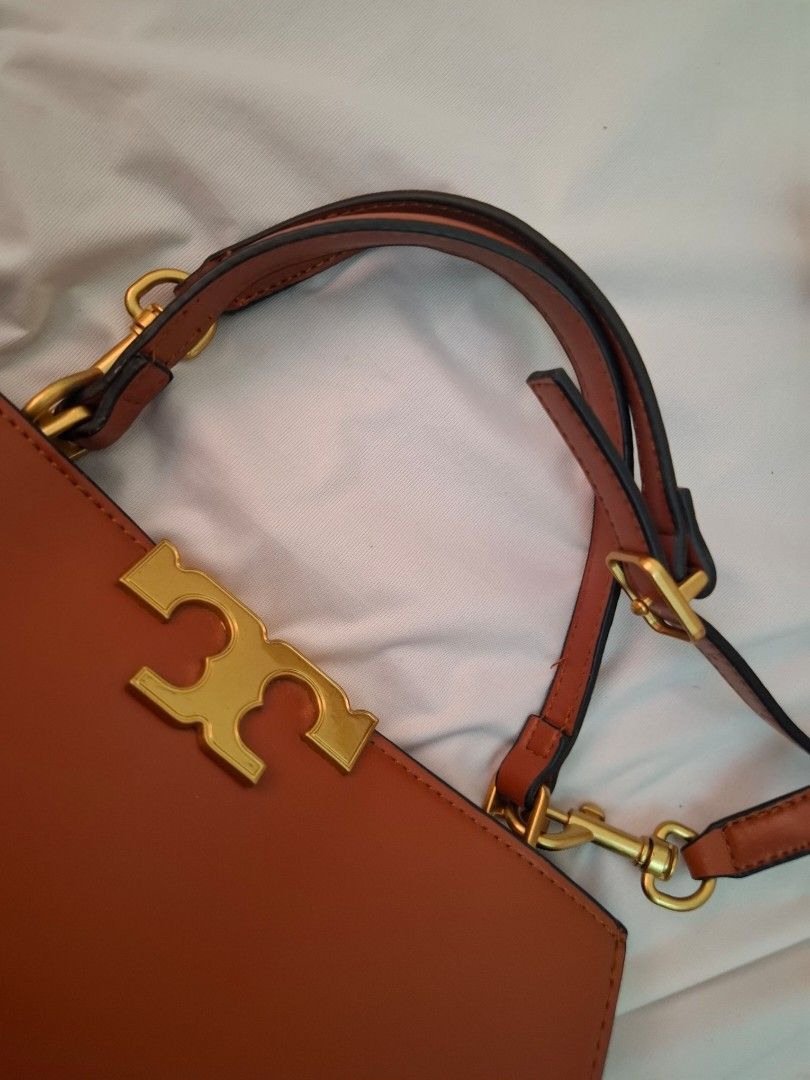Tory Burch Brown Leather Shoulder Bag (Category: Luxury Bags & Wallets) located in Mandaue City. Submitted by mariah_preloved (Listing ID 1427779305, Image 2). Description: Brown leather shoulder bag with gold-tone hardware. Features a detachable shoulder strap and a flap closure with the Tory Burch logo. The interior has multiple compartments. The bottom of the bag has four protective feet. Some wear is visible on the interior lining. Includes a