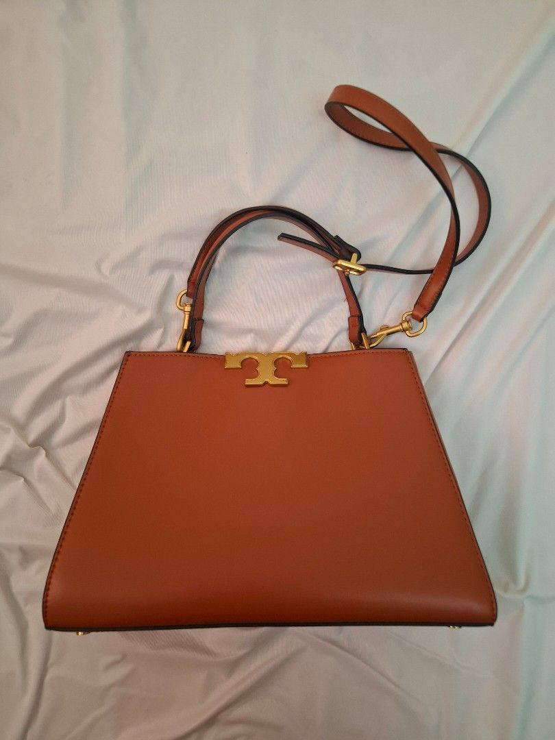 Tory Burch Brown Leather Shoulder Bag (Category: Luxury Bags & Wallets) located in Mandaue City. Submitted by mariah_preloved (Listing ID 1427779305, Image 1). Description: Brown leather shoulder bag with gold-tone hardware. Features a detachable shoulder strap and a flap closure with the Tory Burch logo. The interior has multiple compartments. The bottom of the bag has four protective feet. Some wear is visible on the interior lining. Includes a