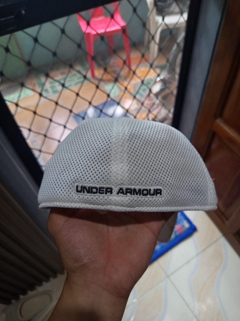 Under Armour Cap (Category: Caps & Hats) located in Davao. Submitted by vaness041421 (Listing ID 1427769482, Image 2). Description: White Under Armour cap. Features the Under Armour logo on the front and the brand name on the side. The cap has a mesh interior. The brim is curved..