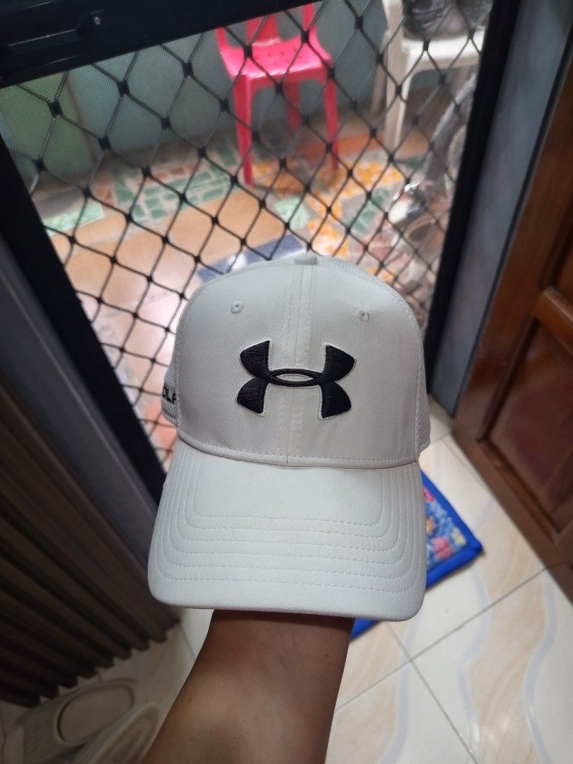 Under Armour Cap (Category: Caps & Hats) located in Davao. Submitted by vaness041421 (Listing ID 1427769482, Image 1). Description: White Under Armour cap. Features the Under Armour logo on the front and the brand name on the side. The cap has a mesh interior. The brim is curved..