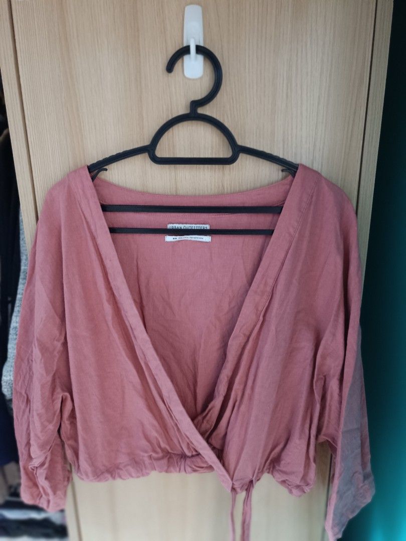 Urban Outfitters Wrap Top (Category: Blouses) located in Trece Martires City. Submitted by declutterbyedi (Listing ID 1427641789, Image 2). Description: Wrap top from Urban Outfitters features a V-neckline and a tie closure at the waist. It has long sleeves and a cropped length. The top is a dusty rose color. The size is M-M..