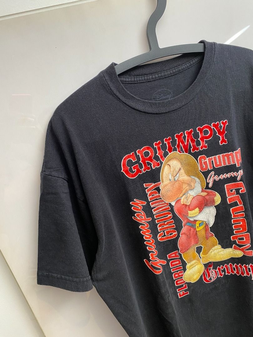 Vintage 90's Disney Grumpy T-shirt (Category: Tshirts & Polo Shirts ) located in Pasig City. Submitted by greatestpickup (Listing ID 1427670899, Image 3). Description: Black t-shirt featuring Grumpy from Disney's Snow White. The design includes the word "Grumpy" in a red font, along with an image of Grumpy. disney grumpy solo red fonts 24.5x30 800.