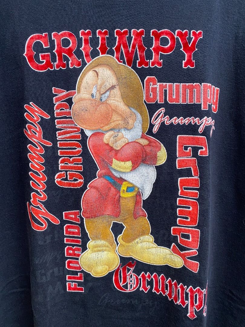 Vintage 90's Disney Grumpy T-shirt (Category: Tshirts & Polo Shirts ) located in Pasig City. Submitted by greatestpickup (Listing ID 1427670899, Image 2). Description: Black t-shirt featuring Grumpy from Disney's Snow White. The design includes the word "Grumpy" in a red font, along with an image of Grumpy. disney grumpy solo red fonts 24.5x30 800.