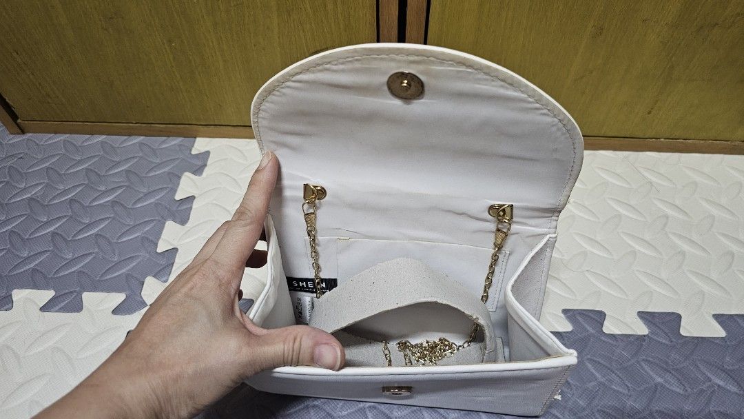 White Handbag with Ruffled Handle (Category: Luxury Bags & Wallets) located in Paranaque City. Submitted by mystuffmel (Listing ID 1427693081, Image 2). Description: Elegant white handbag featuring a unique ruffled handle. It has a flap closure and a gold chain strap inside. The interior is lined with white fabric. Perfect for special occasions or adding a touch of sophistication to your everyday look. payment first and NO COD MOP:GCASH RFS:DECLU
