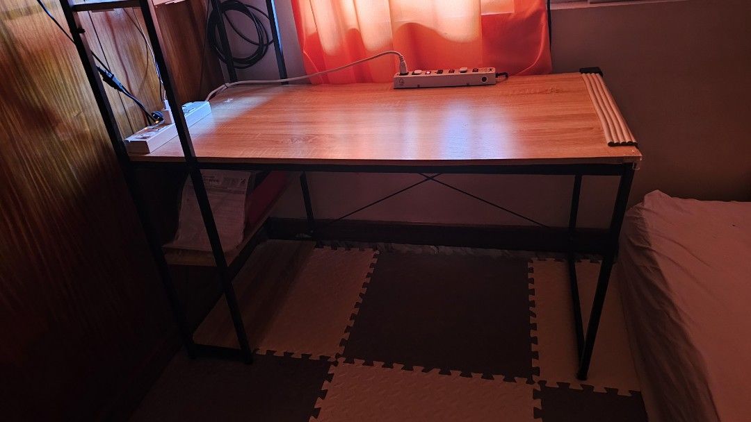 Wooden Computer Desk with Metal Frame (Category: Tables & Sets) located in Paranaque City. Submitted by mystuffmel (Listing ID 1427742327, Image 2). Description: Computer desk features a wooden tabletop and a sturdy black metal frame. It includes a built-in shelf for storage and a power strip. The desk is suitable for a home office or study area. It provides ample space for a computer, monitor, and other accessories. payment first and NO COD MOP: