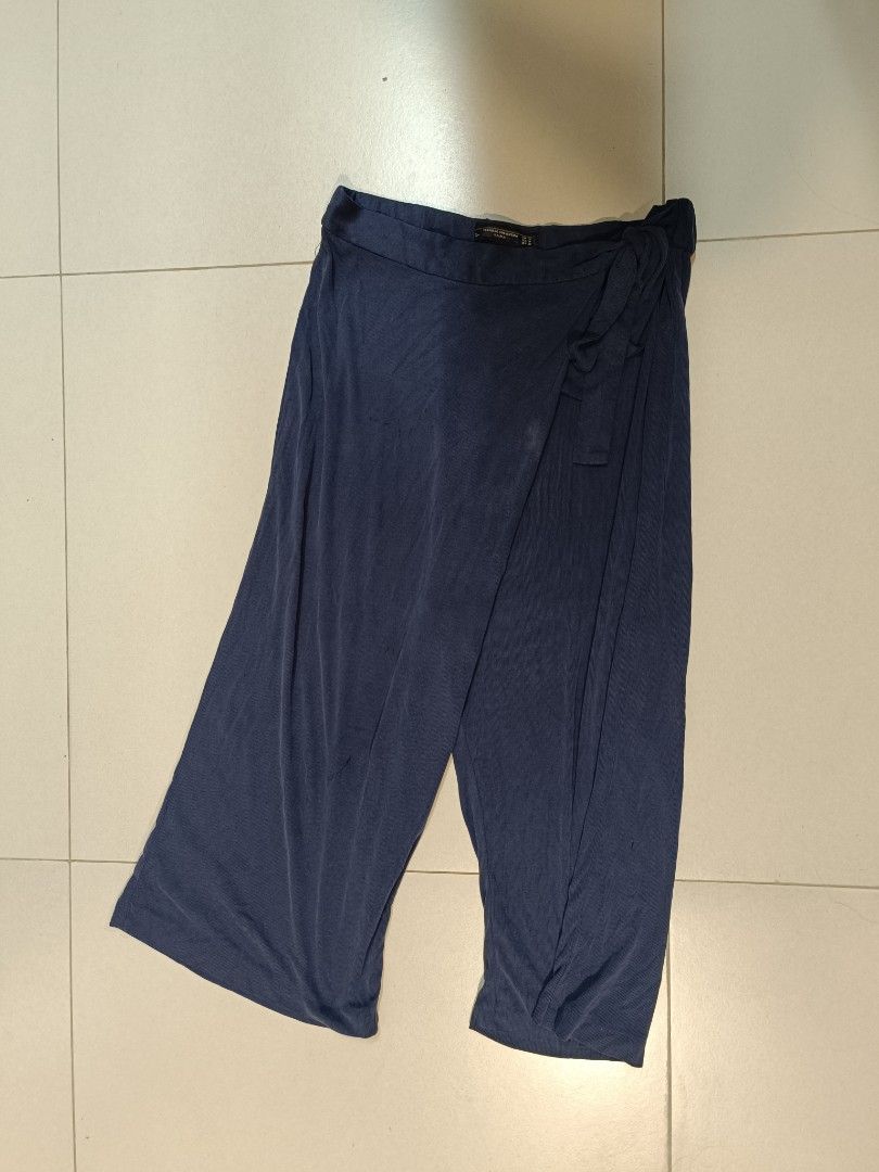 Zara Trafaluc Collection Navy Pants (Category: Other Bottoms) located in Trece Martires City. Submitted by declutterbyedi (Listing ID 1427662864, Image 2). Description: Navy pants from Zara's Trafaluc Collection. Features a unique design with a knot detail. The pants are a size M. The pants have a wide leg cut. Perfect for a casual yet stylish look..