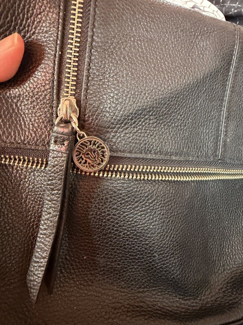Anne Klein Black Leather Crossbody Bag (Category: Cross-body Bags) located in Manila. Submitted by dangschoice (Listing ID 1427791749, Image 1). Description: Black leather crossbody bag by Anne Klein. Features multiple zippered compartments and a magnetic snap closure. The interior is lined with fabric and includes a small pocket. The bag has a long strap for shoulder or crossbody wear. The Anne Klein logo is visible on the zipper pull and inside