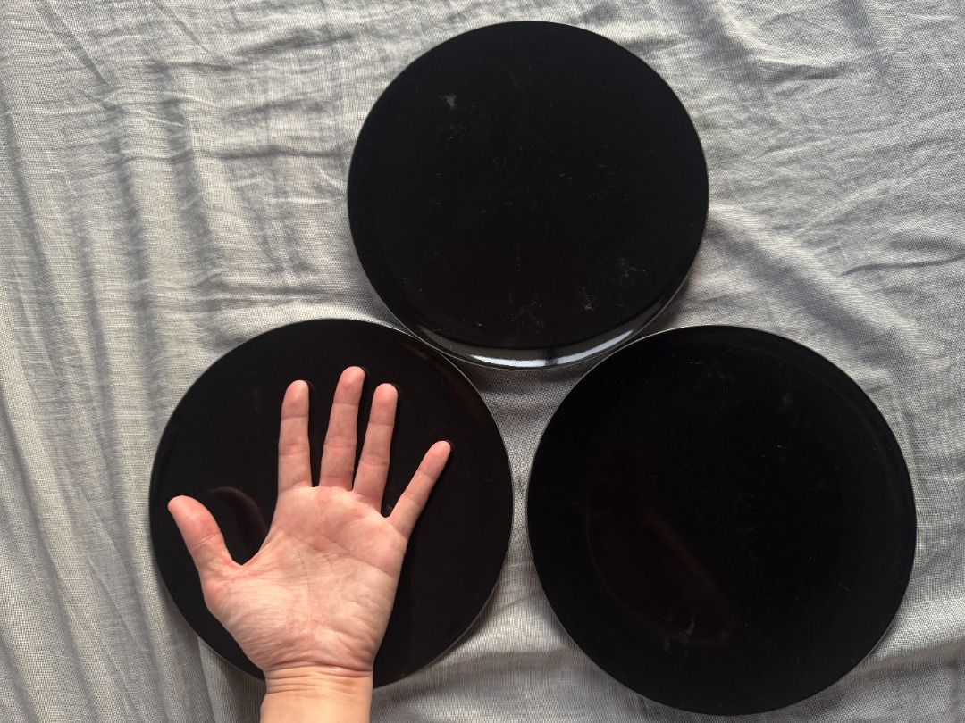 Black Round Plates Set of 3 (Category: Dinnerware & Cutlery) located in Manila. Submitted by ayosditoph (Listing ID 1427863241, Image 1). Description: Set of three black round plates. The plates have a glossy black finish on the top and a light-colored base. The plates appear to be of a standard size, suitable for serving meals..