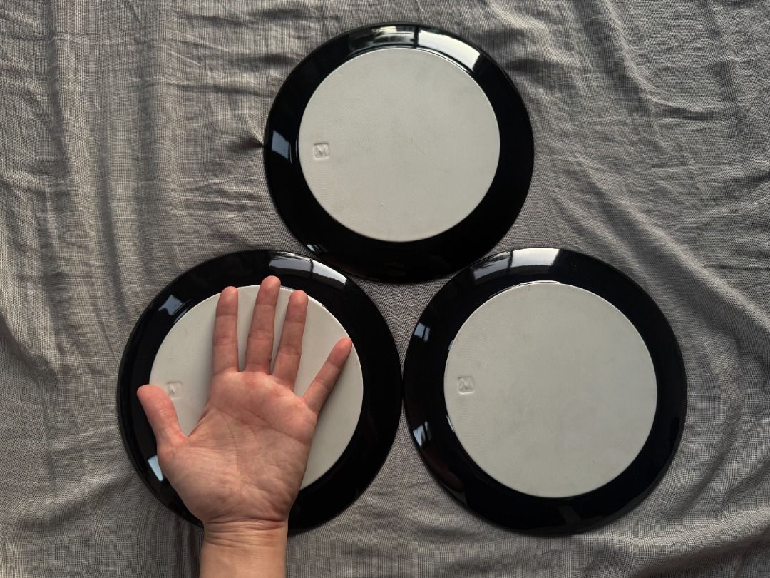 Black Round Plates Set of 3 (Category: Dinnerware & Cutlery) located in Manila. Submitted by ayosditoph (Listing ID 1427863241, Image 3). Description: Set of three black round plates. The plates have a glossy black finish on the top and a light-colored base. The plates appear to be of a standard size, suitable for serving meals..