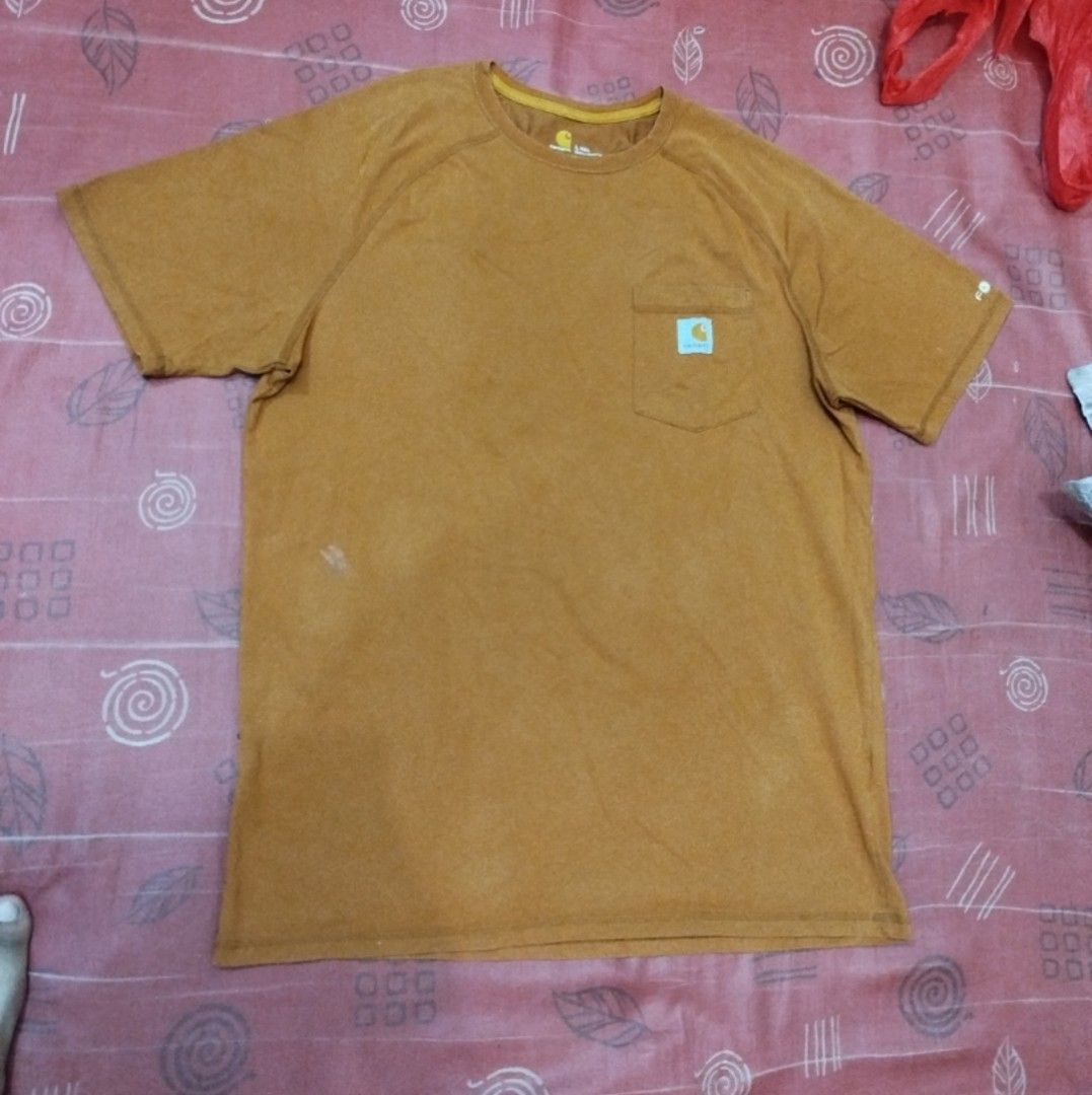 Carhartt Pocket Tee - L Tall (Category: Tshirts & Polo Shirts ) located in Caloocan City. Submitted by vanlemuelv42021 (Listing ID 1427779663, Image 3). Description: Carhartt pocket tee in a brown-orange color. Features a chest pocket with the Carhartt logo. The shirt is a relaxed fit and made in Guatemala. Size is L Tall. The tag indicates it's from the Fall 2020 collection. Made of a cotton-polyester blend..