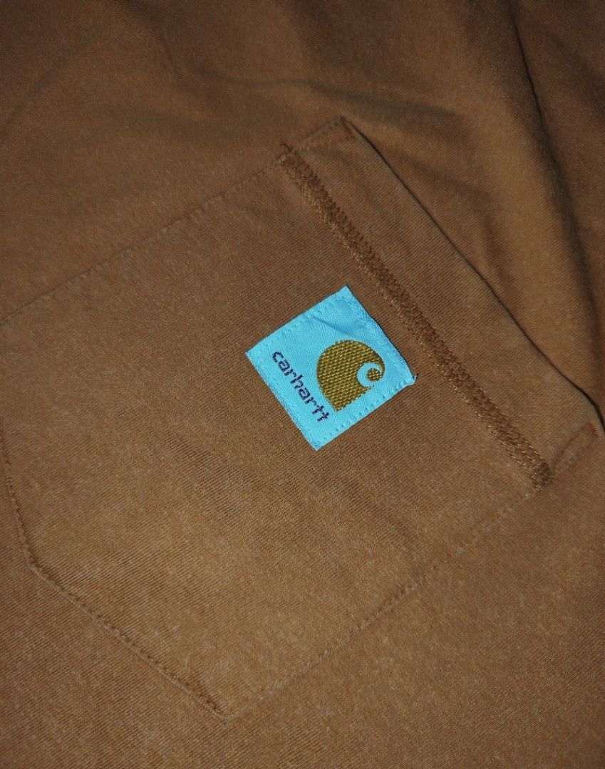 Carhartt Pocket Tee - L Tall (Category: Tshirts & Polo Shirts ) located in Caloocan City. Submitted by vanlemuelv42021 (Listing ID 1427779663, Image 1). Description: Carhartt pocket tee in a brown-orange color. Features a chest pocket with the Carhartt logo. The shirt is a relaxed fit and made in Guatemala. Size is L Tall. The tag indicates it's from the Fall 2020 collection. Made of a cotton-polyester blend..