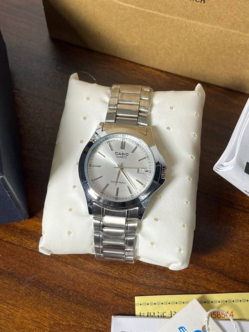 Casio Quartz Watch (Category: Men's Watches) located in Calamba. Submitted by therightky (Listing ID 1427897846, Image 3). Description: Casio Edifice quartz watch with a silver dial and stainless steel band. Comes with the original box, paper bag, and documentation. The watch features a date display..