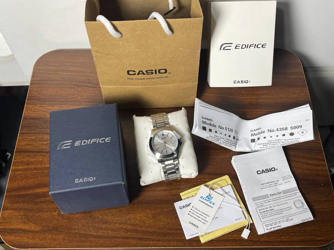 Casio Quartz Watch (Category: Men's Watches) located in Calamba. Submitted by therightky (Listing ID 1427897846, Image 1). Description: Casio Edifice quartz watch with a silver dial and stainless steel band. Comes with the original box, paper bag, and documentation. The watch features a date display..