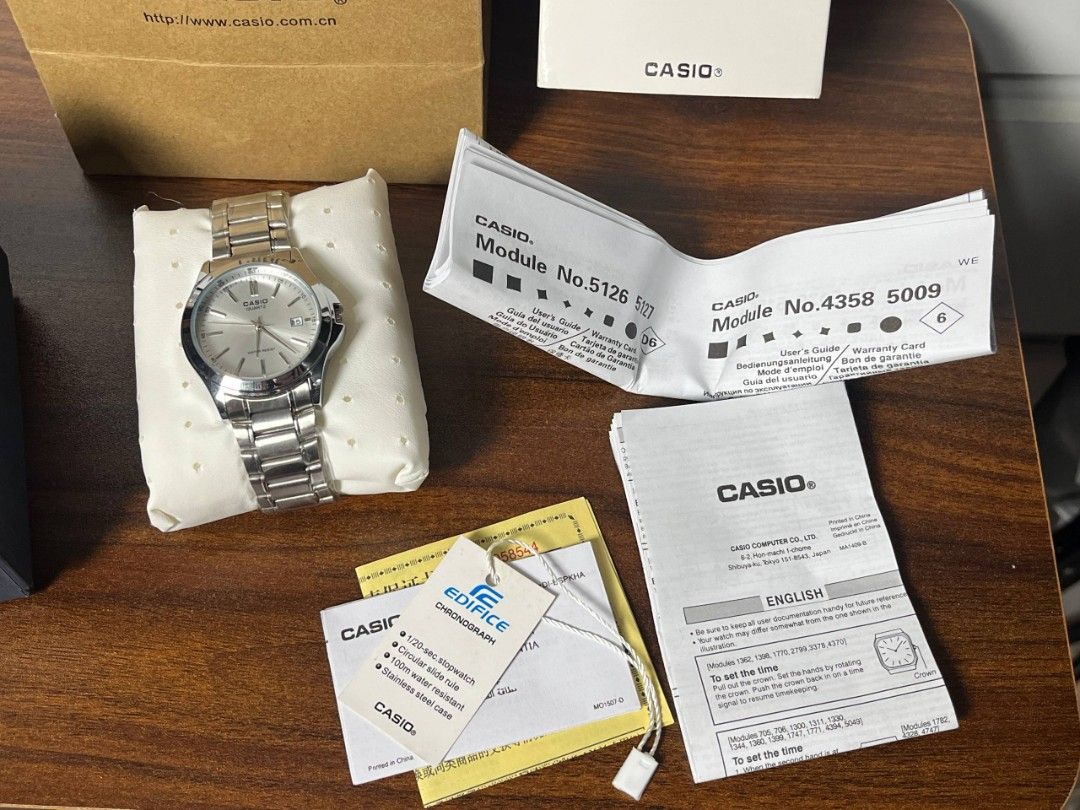 Casio Quartz Watch (Category: Men's Watches) located in Calamba. Submitted by therightky (Listing ID 1427897846, Image 2). Description: Casio Edifice quartz watch with a silver dial and stainless steel band. Comes with the original box, paper bag, and documentation. The watch features a date display..