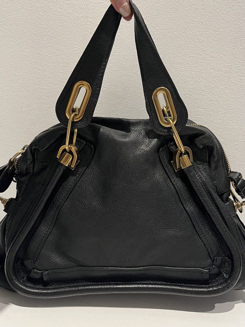 Chloe Paraty Leather Handbag (Category: Luxury Bags & Wallets) located in Manila. Submitted by aki7723 (Listing ID 1427837098, Image 2). Description: Black Chloe Paraty handbag. Features a top zip closure, dual top handles, and a detachable shoulder strap. The interior includes a zip pocket and a Chloe branded leather tag. Made in Italy. The bag has gold-tone hardware and a textured leather exterior..