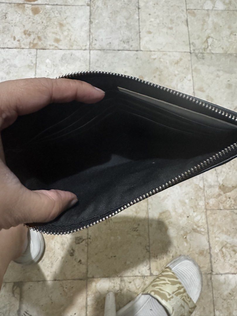 Coach Signature Clutch with Chain (Category: Luxury Bags & Wallets) located in San Juan City. Submitted by idecluttersj (Listing ID 1427906152, Image 3). Description: Black Coach clutch with signature pattern. Features a silver chain strap and a zip closure. The Coach logo is visible on the front of the clutch..