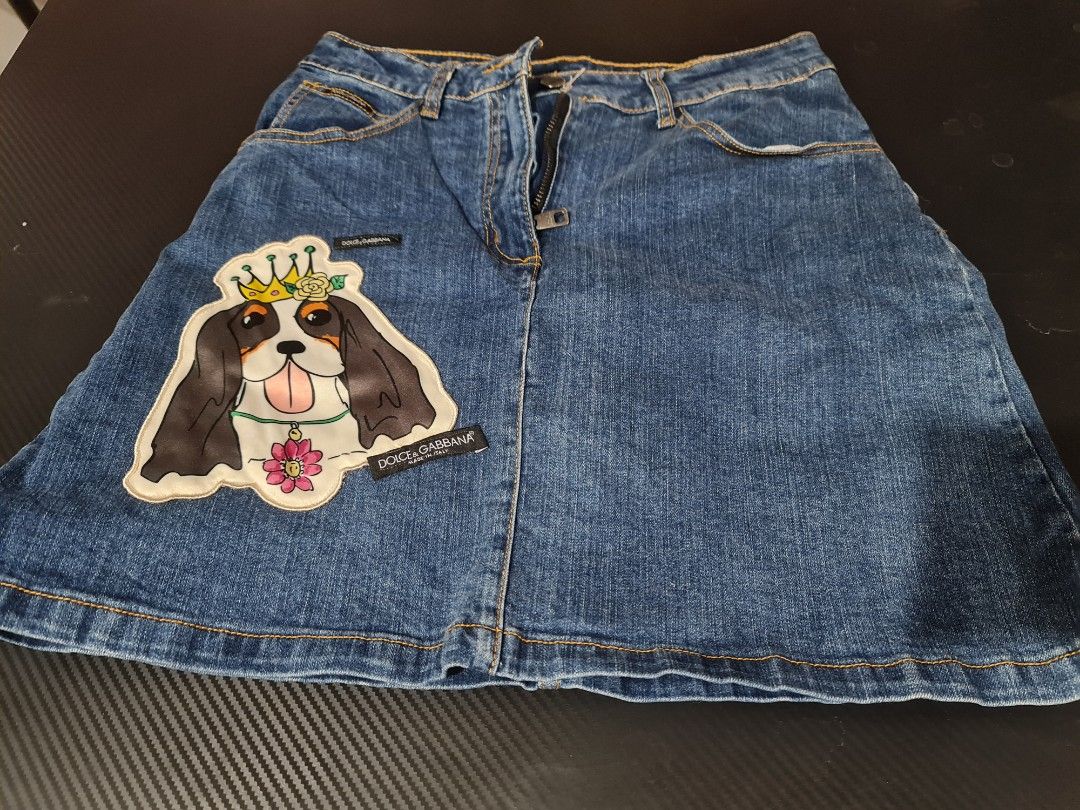 Dolce & Gabbana Denim Skirt (Category: Luxury Apparel) located in Angeles City. Submitted by reallygraceful (Listing ID 1427907226, Image 2). Description: Authentic Dolce & Gabbana Kids denim skirt. Features a unique dog patch design on the front and back. Made in Italy. The skirt has a button and zipper closure. Waist measures approximately 32 inches, and the length is about 17 inches. A stylish and fun piece for any wardrobe..