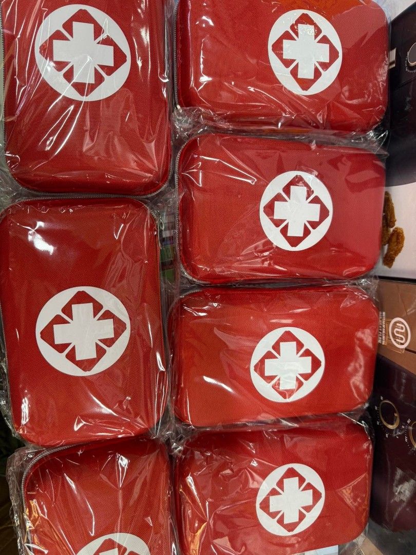 First Aid Kit (Category: Medical Supplies & Tools) located in Manila. Submitted by yzlshop (Listing ID 1427795381, Image 1). Description: Compact red first aid kit. Features a white cross emblem on the front. The kits appear to be sealed in plastic. Perfect for home, travel, or emergency situations. Contains essential medical supplies for minor injuries and first aid needs..