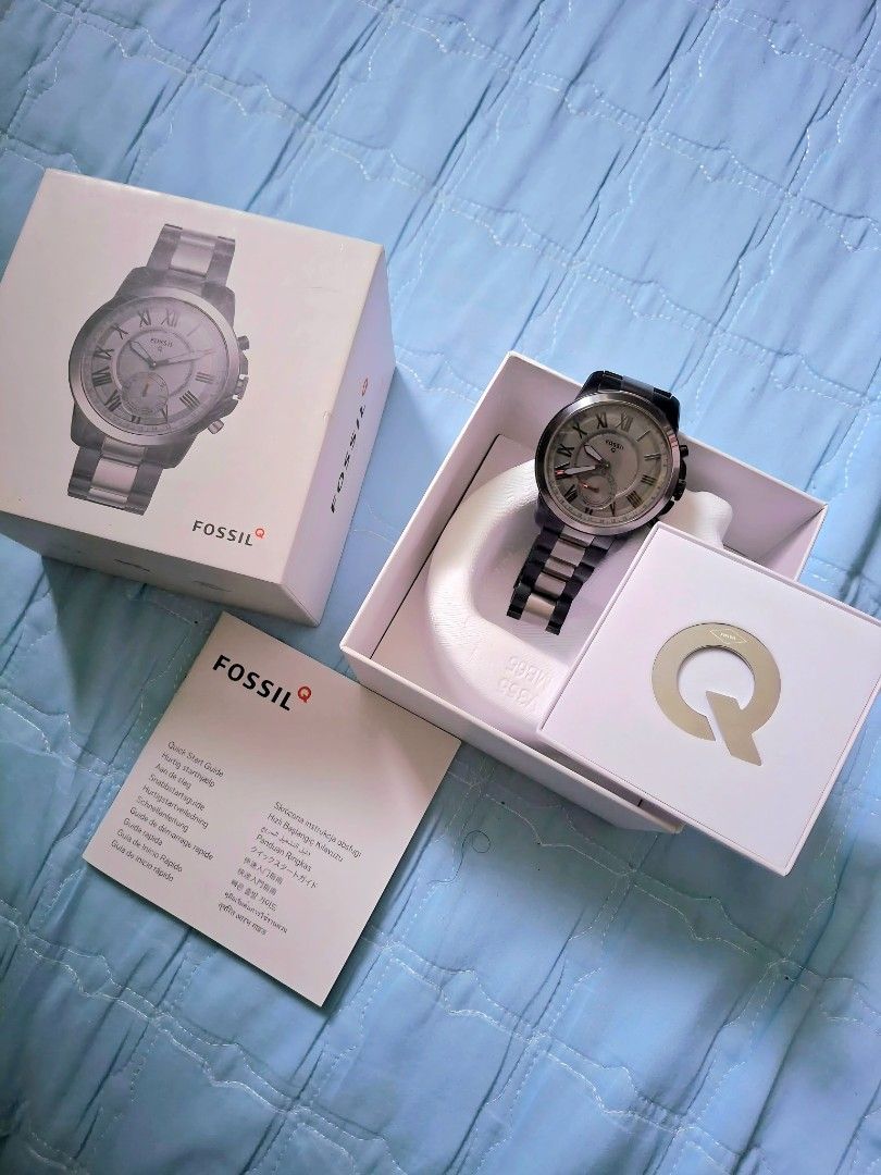 Fossil Q Hybrid Smartwatch (Category: Men's Watches) located in Manila. Submitted by toybuddysnkrs (Listing ID 1427822541, Image 3). Description: Fossil Q Hybrid Smartwatch with a silver and black band. The watch has a grey face with Roman numeral hour markers. Comes with the original box, manual, and charging cable. -lalamove/Gcash -Original -Brand New -Tayuman,Manila.
