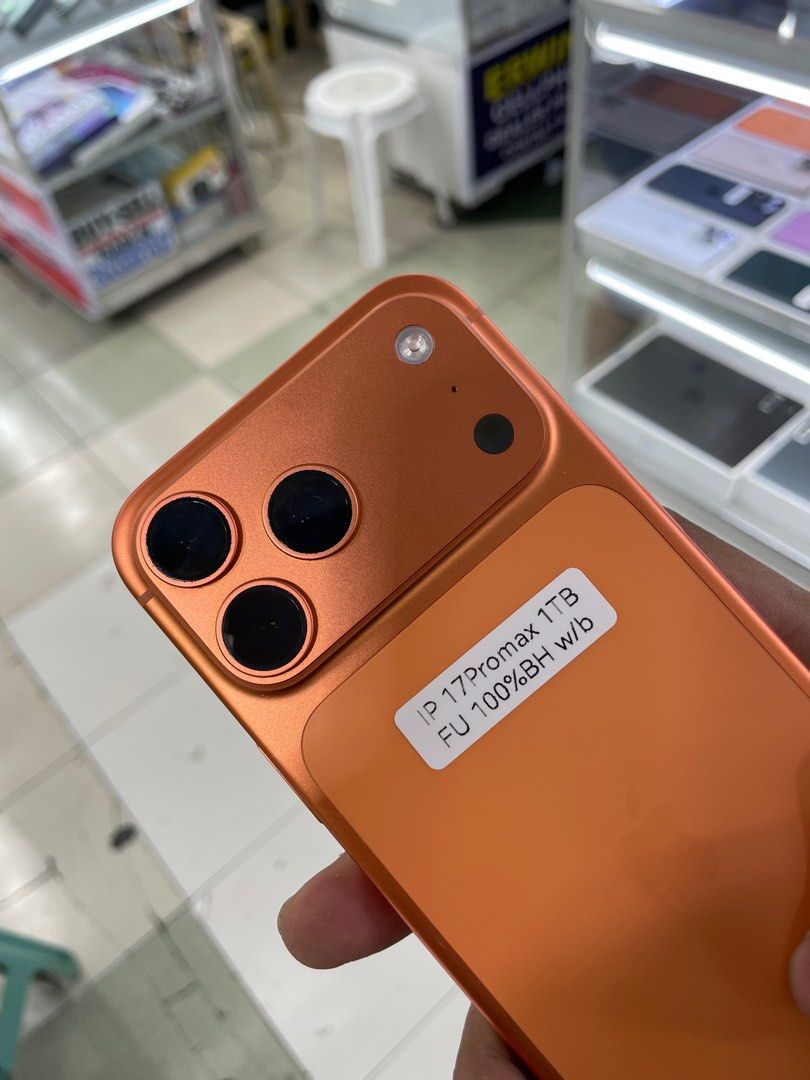 iPhone 17 Pro Max 1TB Complete 100% BH Openline Good as new (Category: iPhone 17 Series) located in Manila. Submitted by benshop. (Listing ID 1427926409, Image 2). Description: FOR SALE | TRADE/SWAP BenShop Price : 98,000 php ▫️On hand: iPhone 17 Pro Max ▫️1TB ▫️Openline/Factory unlocked ▫️Orange ▫️100% Batt health ▫️Ntc Local Variant ▫️Complete Original box ▫️All Features Working INCLUSIONS & FREEBIES: *CHARGER SET *CLEAR CASE *TEMPERED GLASS MO