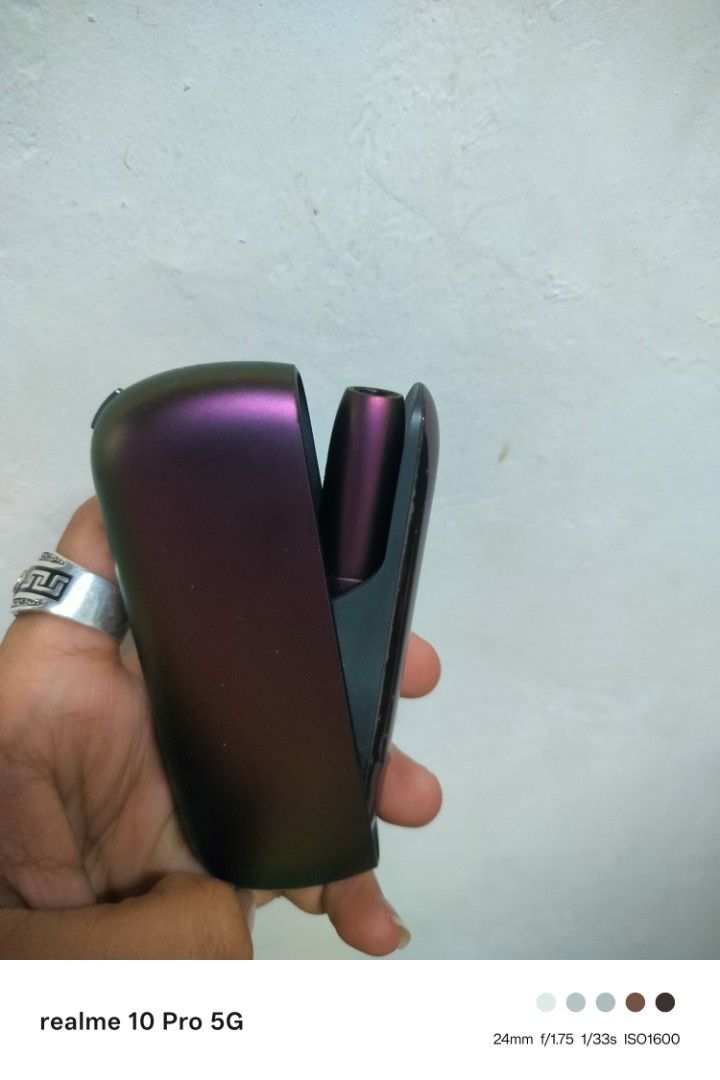 IQOS 3 duo (Category: Other Gadgets) located in Manila. Submitted by cleverturtle-2982 (Listing ID 1427933896, Image 3). Description: IQOS ILUMA Prime device. It has a sleek, dark purple finish. The device includes the holder and the charger. The images show the device in various angles, including the holder and charger..