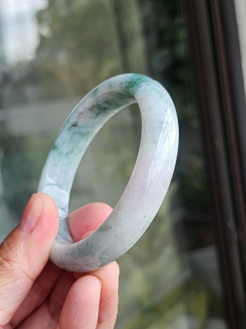 Jadeite Jade Bangle size 55.6 authentic with Certificate (Category: Bracelets) located in Manila. Submitted by cavalierdolls (Listing ID 1427821135, Image 1). Description: Beautiful jadeite jade bangle with a mix of green and white hues. The bangle has a smooth, polished surface size 55.6mm with Certificate. The jadeite jade is translucent, allowing light to pass through. It is a perfect accessory for everyday wear or special occasions..