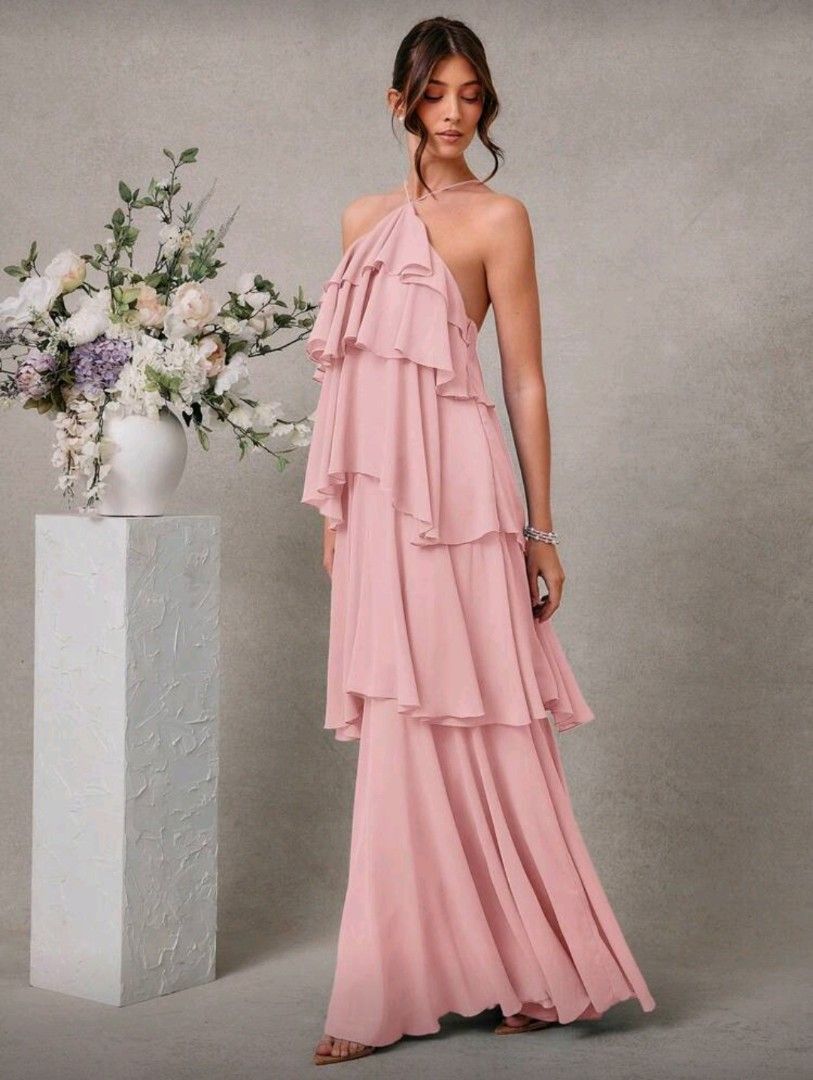 L'Amorae Ruffled Halter Maxi Dress (Category: Dresses) located in Manila. Submitted by may.lc (Listing ID 1427828685, Image 1). Description: Elegant maxi dress featuring a halter neckline and tiered ruffles. The dress has a flowing silhouette and a low back design. It is a soft pink color, perfect for special occasions. It is a floor-length gown. used once for a photoshoot. .