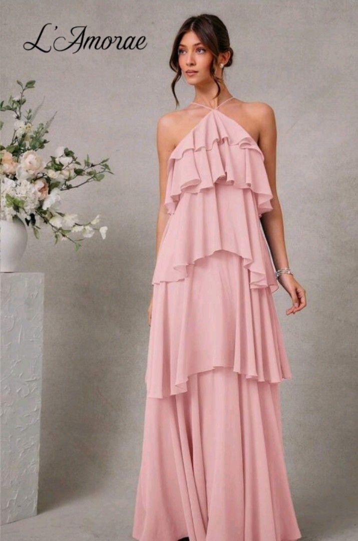 L'Amorae Ruffled Halter Maxi Dress (Category: Dresses) located in Manila. Submitted by may.lc (Listing ID 1427828685, Image 3). Description: Elegant maxi dress featuring a halter neckline and tiered ruffles. The dress has a flowing silhouette and a low back design. It is a soft pink color, perfect for special occasions. It is a floor-length gown. used once for a photoshoot. .