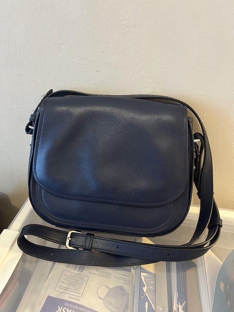 Marc Jacobs Navy Blue Crossbody Bag (Category: Luxury Bags & Wallets) located in Mandaluyong City. Submitted by geri3373 (Listing ID 1427855990, Image 1). Description: Navy blue crossbody bag by Marc Jacobs. Features a flap closure with a magnetic snap. The interior includes a zippered pocket and a slip pocket. The bag has a long adjustable strap. The hardware is silver.