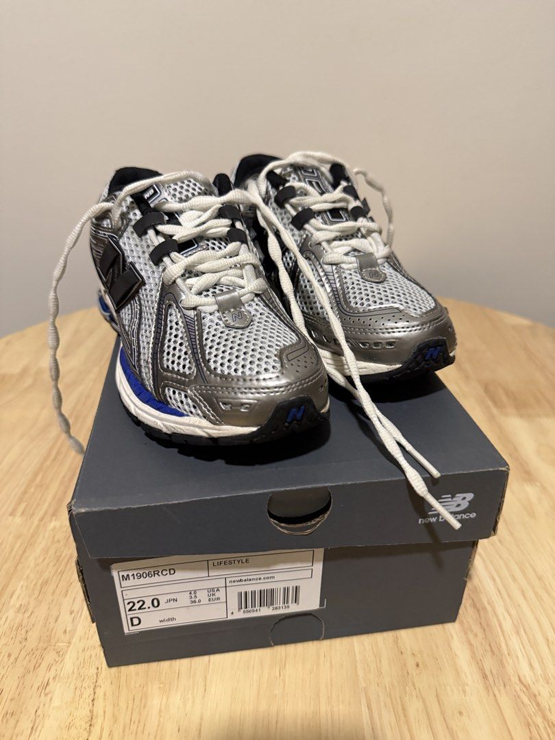 New Balance M1906RCD Sneakers (Category: Sneakers) located in Taguig. Submitted by decmnl (Listing ID 1427880832, Image 1). Description: New Balance M1906RCD sneakers. Features a gray mesh upper with silver and blue accents. The shoes have a blue midsole and a black outsole. Comes with the original box. Size 22.0.Bought from Pasabuy Japan at aroun Php6,000 and used for 3x only..
