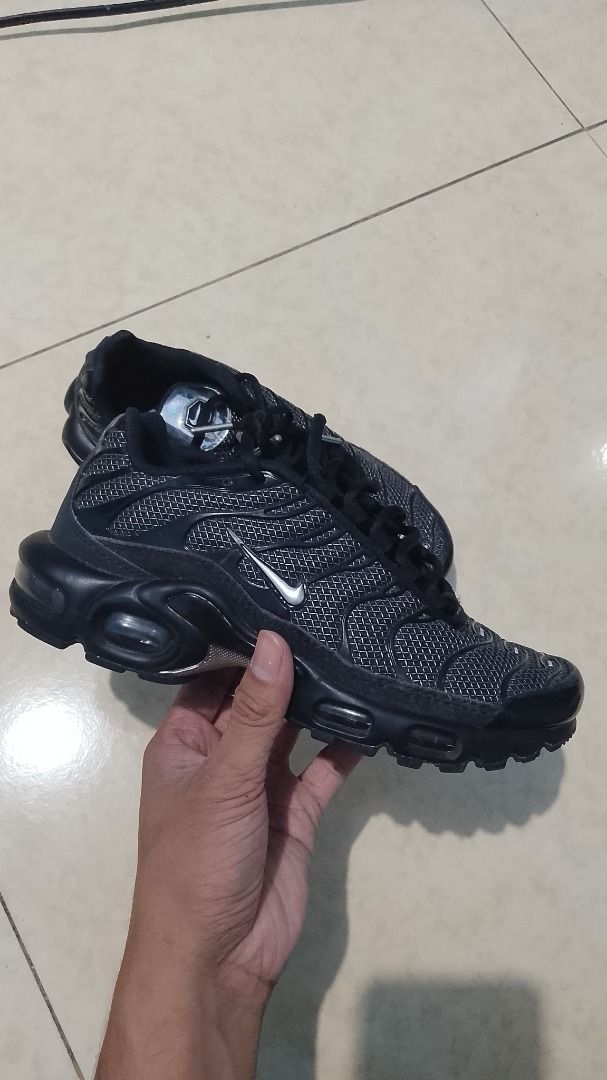 Nike Air Max Plus TN Metalic Black (Category: Sneakers) located in Pateros City. Submitted by blvd_store (Listing ID 1427787215, Image 1). Description: Nike Air Max Plus TN in black. Features a black mesh upper with signature TPU overlays. The shoe has a visible Air Max unit in the heel and a rubber outsole for traction. The size is UK 3, EUR 36, and US 5.5. Made in Indonesia..