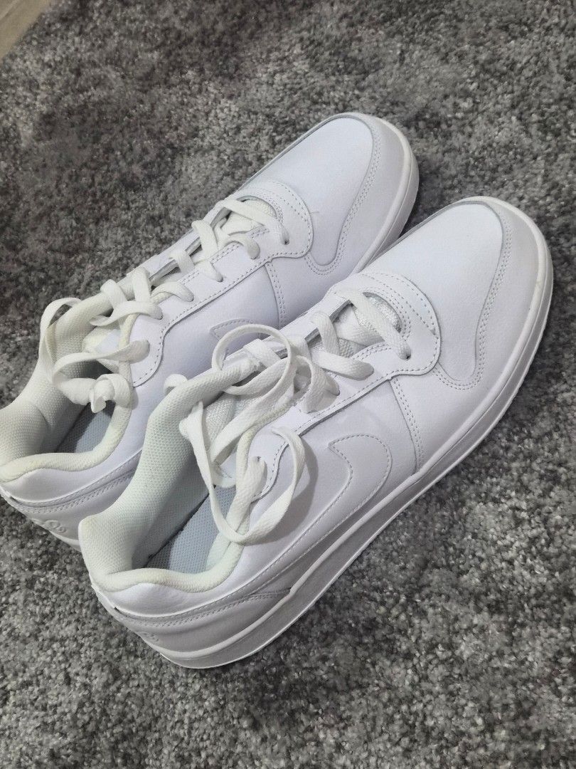 Nike Men's Ebernon Low Shoes - Triple White (Category: Sneakers) located in Pasay City. Submitted by frannymae1211 (Listing ID 1427906232, Image 1). Description: White Nike Ebernon Low shoes. The shoes are size US 12, EUR 46, and CM 30. The style code is AQ1775-100. The shoes have a white sole and a white Nike swoosh logo on the side. Brand new and authentic but no box. Received as a gift. Rfs, Decluttering .