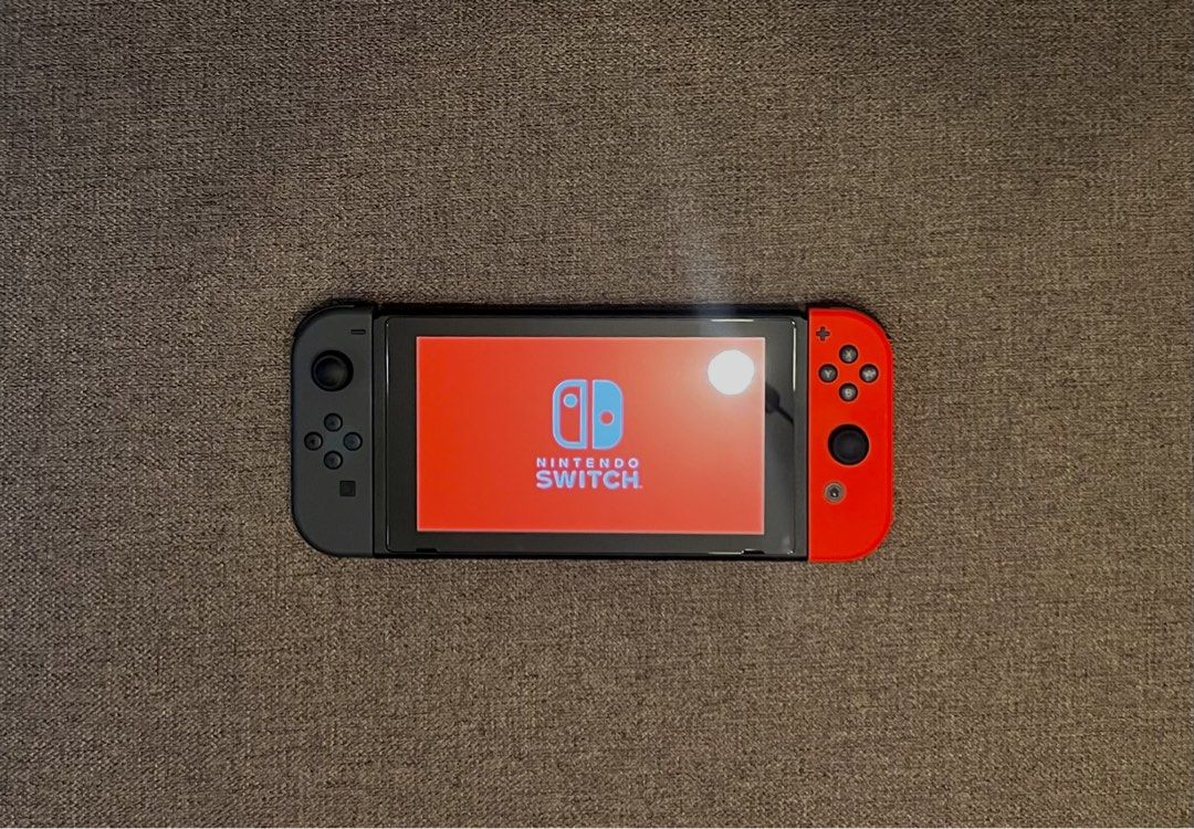 Nintendo Switch 1 V2 Gray & Red [Bundle] (Category: Nintendo) located in Manila. Submitted by joshdecluttering (Listing ID 1427916974, Image 2). Description: In pristine and excellent working condition. Grip case and screen protector from purchase. No box. Comes with: - Unit - Original Dock - Red and Gray Controller - Joycon Grip - Joycon Strap - Original Charger - Original HDMI cable - Sandisk 128gb MicroSD - Ugreen Grip Case Protector [value P7