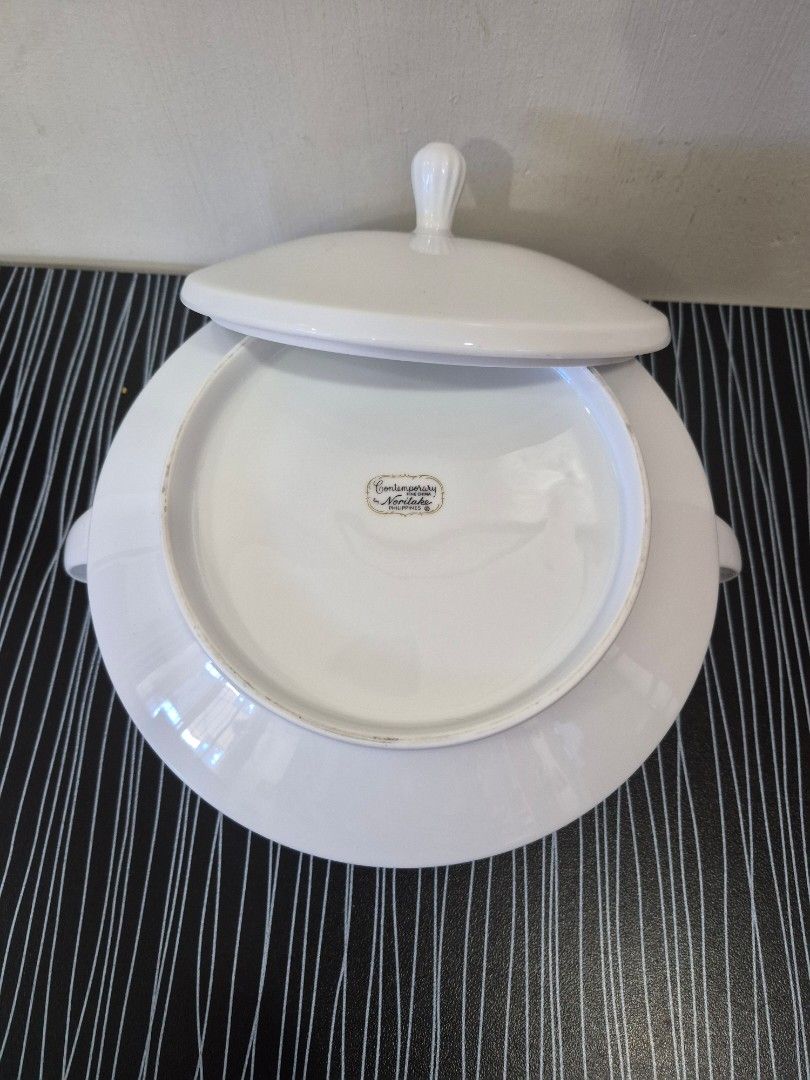 Noritake Legacy White Soup Tureen with Lid (Category: Dinnerware & Cutlery) located in Cainta. Submitted by gerlaystreasures (Listing ID 1427810568, Image 2). Description: Aurhentic Noritake Legacy Series Product 3.5 inches deep 8.5 inches wide Elegant white soup tureen with a matching lid. Features two side handles for easy carrying and a decorative knob on the lid. The tureen has a classic, rounded shape. The bottom of the tureen has a brand ma