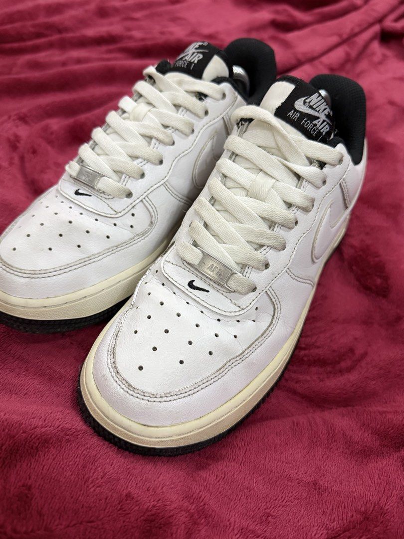 Original Nike Air Force 1 Low White Black (Category: Sneakers) located in Manila. Submitted by branded_preloved14 (Listing ID 1427913269, Image 2). Description: Classic Nike Air Force 1 Low in white and black. Features the iconic Nike swoosh on the sides. The shoes have a white leather upper with a black accent on the heel and tongue. The soles are off-white with a black outsole. Size 7 US. Includes shoe trees. No box. Needs wash. .