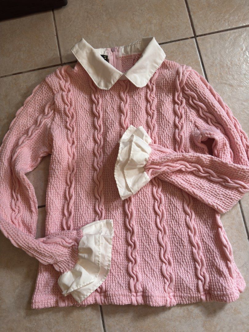 Pink Cable Knit Sweater with White Collar (Category: Longsleeves) located in Manila. Submitted by jamein (Listing ID 1427800996, Image 2). Description: Pink sweater features a cable knit design with a white collar and cuffs. It has long sleeves and a zipper at the back. The cuffs have a ruffled detail. It is a light pink color..