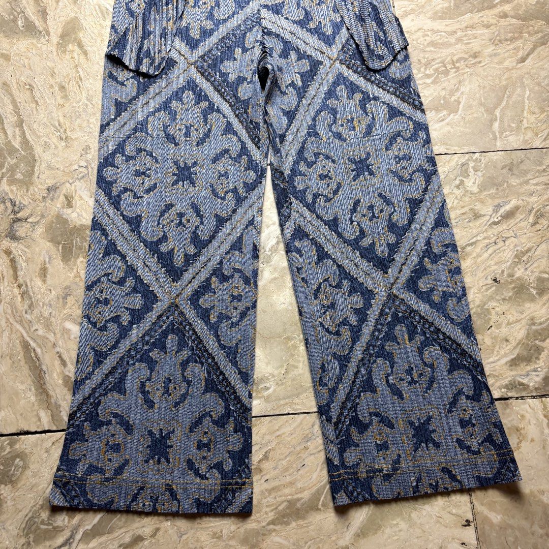Pleats Please Issey Miyake Printed Pants Size 4 (Category: Other Bottoms) located in Dinalupihan. Submitted by hell.thrift (Listing ID 1427800670, Image 2). Description: Pleats Please pants with a unique blue and gold geometric print. Features a wide-leg design with pleated details. Made in Japan. Size 4. The fabric is 100% polyester. Includes care instructions: minimum machine wash, do not bleach, iron, tumble dry, or dry clean. Clean in net..