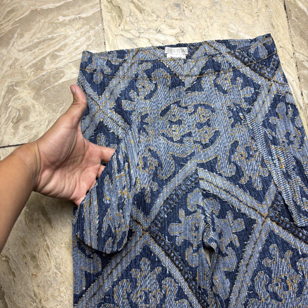 Pleats Please Issey Miyake Printed Pants Size 4 (Category: Other Bottoms) located in Dinalupihan. Submitted by hell.thrift (Listing ID 1427800670, Image 3). Description: Pleats Please pants with a unique blue and gold geometric print. Features a wide-leg design with pleated details. Made in Japan. Size 4. The fabric is 100% polyester. Includes care instructions: minimum machine wash, do not bleach, iron, tumble dry, or dry clean. Clean in net..
