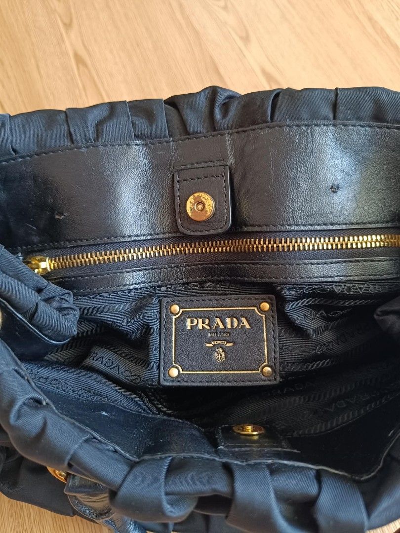 Prada Black Nylon Handbag (Category: Luxury Bags & Wallets) located in Muntinlupa City. Submitted by luxbagsandapparelsph (Listing ID 1427863978, Image 3). Description: Pre-owned Prada Tessuto Gaufre Nylon Tote Bag This item has no inclusions. In good condition with minimal signs of use. This may include fading of hardwares or plating and scratches. Declared flaws: Missing hangtag and sling. Deformed handle Please refer to the photos on this prod