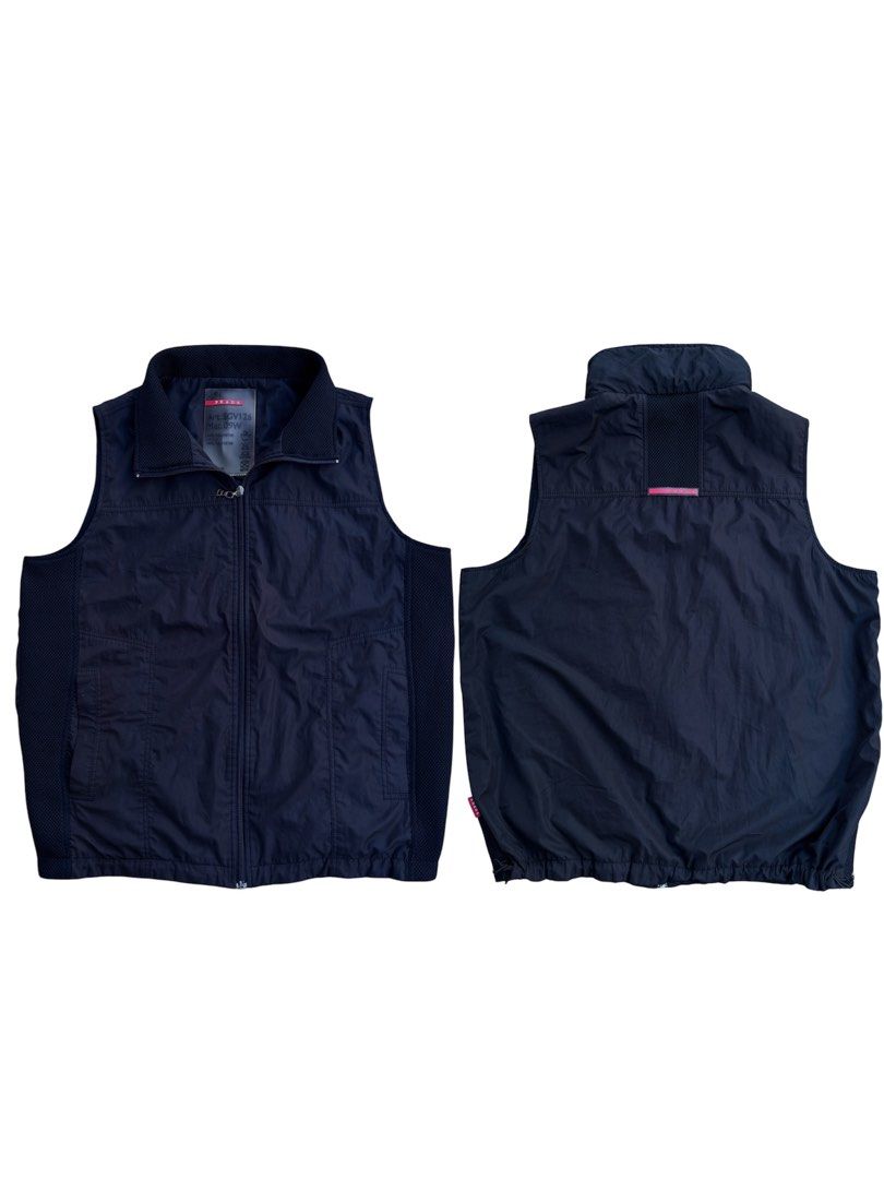 Prada SGV126 Vest (Category: Vests) located in Calamba. Submitted by thrifthstlrs (Listing ID 1427861830, Image 1). Description: Navy blue Prada vest. Features a full zip closure and a stand-up collar. The vest has a mesh lining and a drawstring hem. The label indicates the model number SGV126 and is made of 100% polyester. The zipper has the Prada logo..