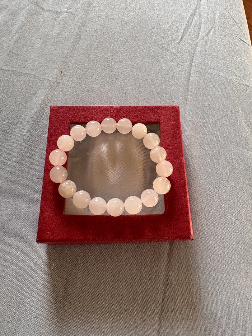 Rose Quartz Bead Bracelet (Category: Bracelets) located in Quezon City. Submitted by brandedthingsforless (Listing ID 1427934381, Image 1). Description: Bracelet features round, light pink rose quartz beads. The beads are strung together on an elastic band. It is presented in a red box..